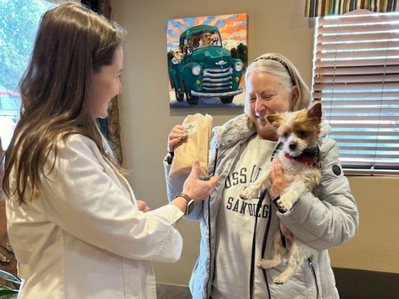 vet handing off a dog medication prescription